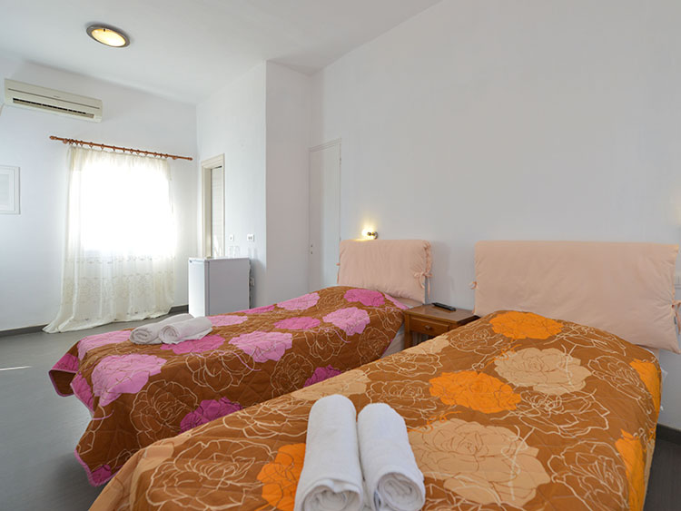 Interior of a double room with twin beds at Cyclades Beach in Sifnos