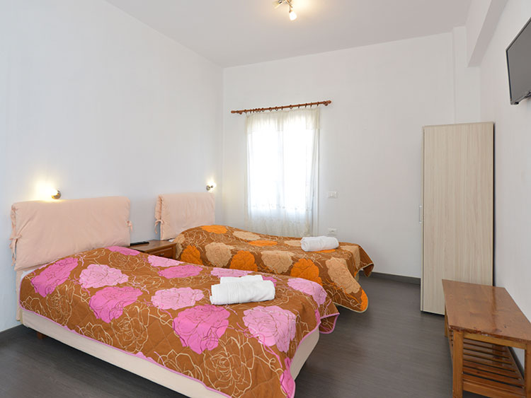 Intérieur d'une chambre double avec lits jumeaux à Cyclades Beach à Sifnos
